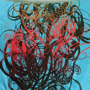 May include: A blue pillowcase with a black and red abstract design. The design features swirling lines and shapes.