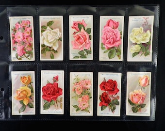 May include: A collection of ten vintage cigarette cards featuring different varieties of roses. Each card has a colorful illustration of a rose with its name printed below. The cards are all from the Wills's Cigarettes brand.