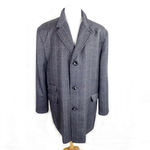 May include: A gray, three-button overcoat with a subtle pinstripe pattern. The coat features a notched lapel, two front pockets, and a classic tailored fit. The coat is displayed on a mannequin.