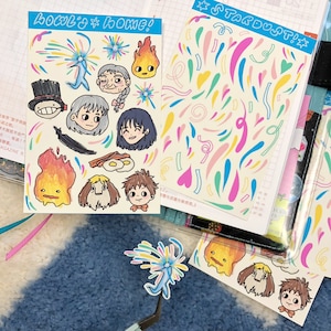 May include: A set of colorful stickers featuring cartoon characters and whimsical designs. The stickers are on a white background with the text "Locul's* home!" and "STARDUST!☆".