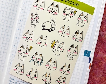 May include: A sheet of stickers featuring various illustrations of white cats with different facial expressions. The stickers are on a white background with black outlines. The text "toro inoue" is printed in green at the top of the sheet.