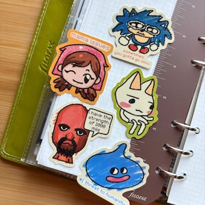 Pode incluir: Uma coleção de autocolantes desenhados à mão com personagens de desenhos animados e texto. Os autocolantes incluem uma personagem com o texto "mama issues", um ouriço-cacheiro azul com o texto "sometimes you gotta go slow" e uma gota azul com o texto "#1 threat to humanity".