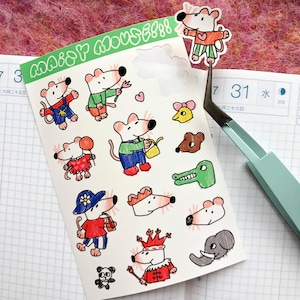 May include: A sheet of colorful mouse stickers with various outfits and accessories. The stickers feature cartoon mice in different poses, including holding flowers, watering cans, and wearing hats. The text "MAISY MOUSE!!!" is printed in green on the top left.