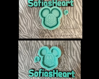 May include: A teal silicone mould shaped like a cartoon mouse head with a small matching accent piece. A clear ruler shows the mould is approximately 7.5 cm wide. The text SofiasHeart is displayed in teal letters with a black outline.