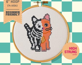 Puede incluir: Un patrón de punto de cruz en un bastidor de madera con un gato dividido por la mitad, con un lado mostrando un esqueleto en blanco y negro y el otro un gato naranja. El texto en la imagen dice FITS ON 6" HOOP (14 AIDA) BEGINNER FRIENDLY.