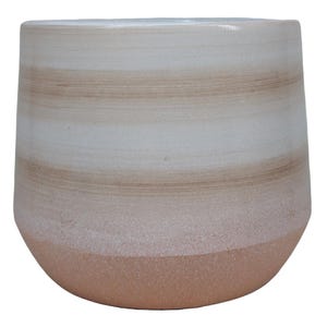 May include: A white ceramic planter with a light brown ombre design. The planter has a rounded bottom and a wide opening.