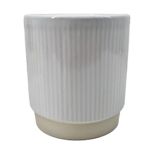 May include: White ceramic planter with vertical lines and a beige base.
