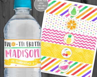 May include: Water bottle labels with a colorful fruit theme. The labels feature a variety of fruits, including a pear, orange, pineapple, cherries, lemon, and watermelon. The labels are designed for a birthday party with the text "Two-tti Frutti Madison is turning 2".