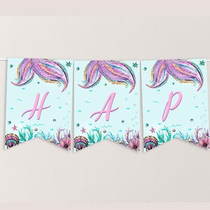 May include: A blue and pink mermaid-themed banner with the word "HAP" in pink letters. The banner features glitter, seashells, and mermaid tails.