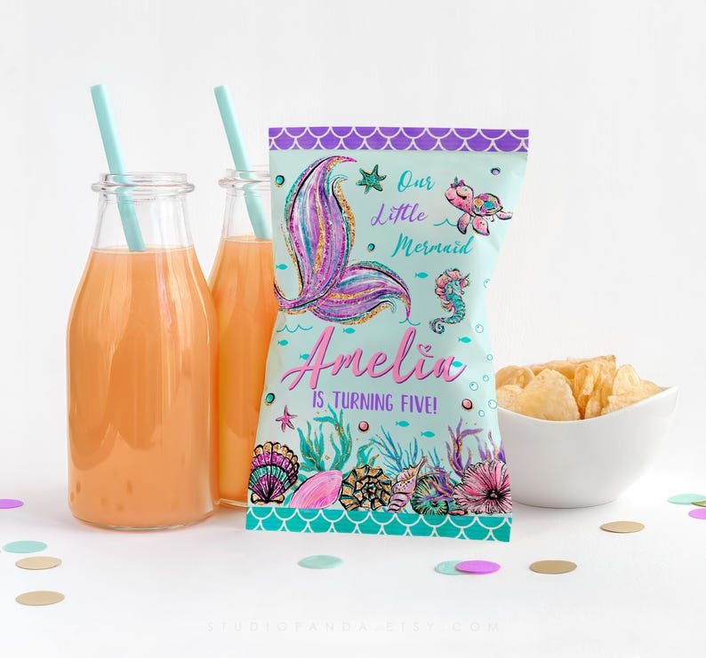 May include: A teal blue and purple mermaid-themed party favor bag with a glittery pink mermaid tail, a seahorse, and a turtle. The bag says "Our Little Mermaid Amelia is turning five!"
