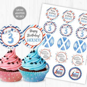 May include: Blue and red cupcake toppers featuring a train, clouds, and the number 3. The toppers read "Happy Birthday! Jackson" and "Choo Choo".