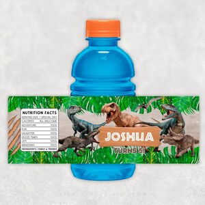 May include: A blue water bottle with a green and brown label featuring dinosaurs and the text "NUTRITION FACTS" and "JOSHUA TURNS 5!"
