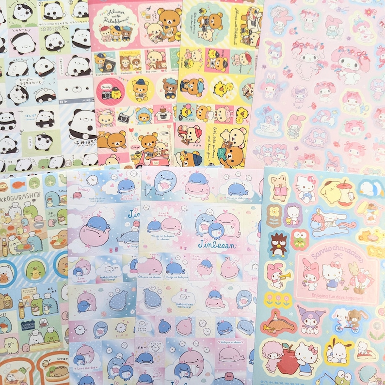 May include: A selection of colourful sticker sheets showcasing cartoon characters. Designs include pandas, bears, whales, and Sanrio characters. The stickers are in various shapes and sizes, with a pastel colour palette.