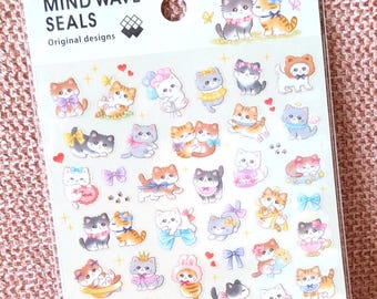 May include: A sheet of Mind Wave Seals stickers featuring various illustrations of cats in different poses, colors, and accessories. The packaging includes the text Little Mewny and Original designs, with numerous small cat stickers arranged on a clear backing.