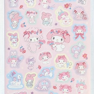May include: A sheet of pink stickers featuring illustrations of a cartoon character with a pink bow and bunny ears. The stickers have a light blue outline and include flowers and other decorative elements.