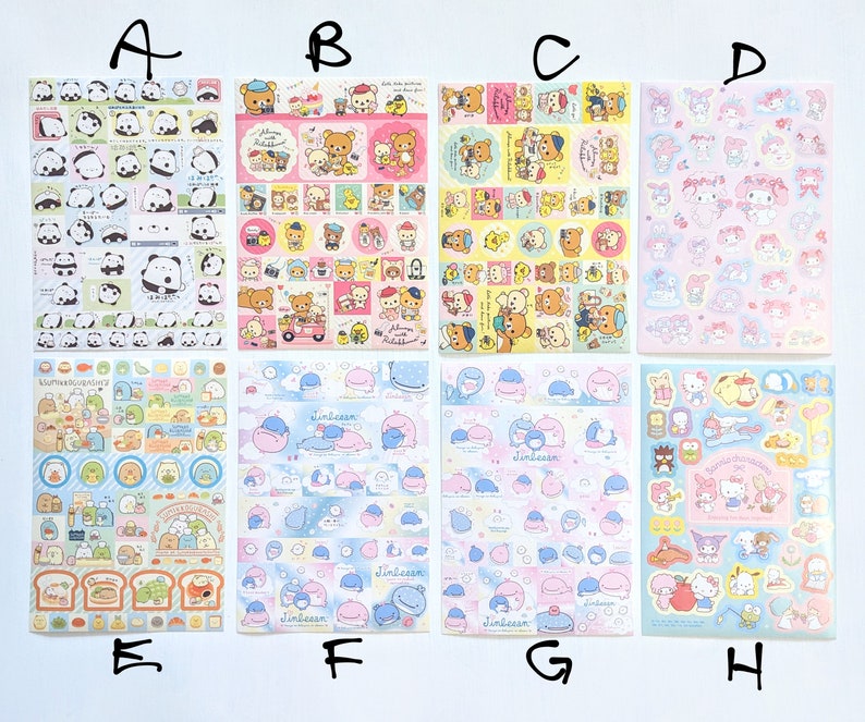 May include: A selection of sticker sheets with cartoon characters. The sheets display designs with pandas, bears, and other cute illustrations in pink, blue, and yellow. These stickers are suitable for scrapbooking and crafts, perfect for adding a touch of fun.