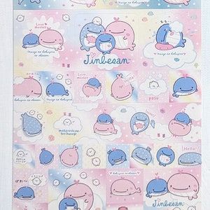 May include: A sheet of stickers featuring cartoon whales in various poses. The stickers are primarily pink and blue, with some text and cloud designs. The text includes "Hello!" and "Jinbesan".