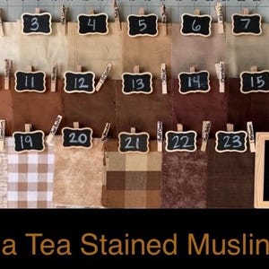 May include: A collection of twenty-three fabric swatches in various shades of brown, beige, and cream, each labeled with a numbered chalkboard tag. A larger chalkboard sign in the bottom right corner displays the text Body Fabric.