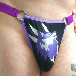May include: Purple and black underwear with a purple wolf graphic.