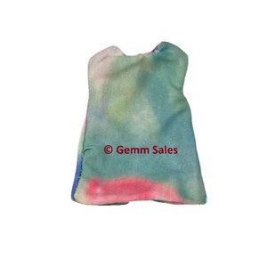 May include: A sleeveless doll dress featuring a tie-dye pattern in shades of teal, pink, and white. The garment has a rounded neckline and a flared silhouette. The text "© Gemm Sales" is printed in dark red across the center of the fabric.