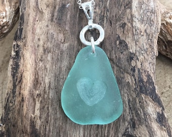 Seafoam Sea Glass hand carved insett heart pendant with 18  inch sterling chain .