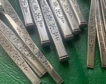 May include: A set of silver flatware with an ornate floral design. The forks and spoons have a decorative pattern of flowers and leaves.
