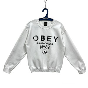 OBEY Werbung No 89 Rundhals-Sweatshirt Weiss Obey Pullover Pullover Obey Logo Print Streetwear Weiss S
