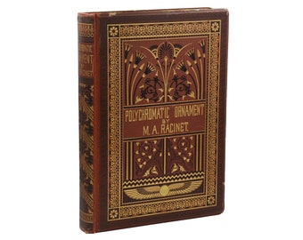 May include: A vintage book titled "Polychromatic Ornament by M.A. Racinet" with a brown leather cover and gold-colored decorative details. The cover features an intricate design with stylized plants and geometric patterns.