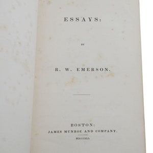 May include: A book titled "Essays" by R. W. Emerson, published in Boston by James Munroe and Company in 1841.