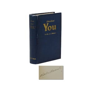 May include: A blue hardcover book titled "A Book About You" with gold lettering. The book is signed by Charles F. Haanel.