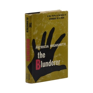 May include: A yellow book cover with a black hand reaching out. The title "The Blunderer" is in red and black letters. The author is Patricia Highsmith. The book is a new thriller by the author of "Strangers on a Train."