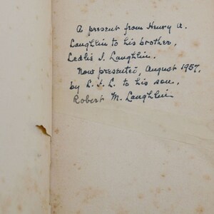 May include: A handwritten note on a page of a book. The note reads: "A present from Henry A. Laughlin to his brother, Ledlie J. Laughlin. Now presented, August 1957, by H.L. to his son, Robert M. Laughlin."