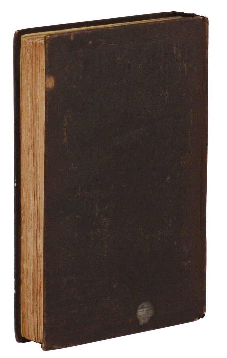 May include: A dark brown hardcover book with a worn, aged appearance. The book has a spine with visible stitching and a slightly raised cover.