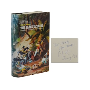 May include: A book titled "The Black Jacobins: Toussaint L'Ouverture and the San Domingo Revolution" by C.L.R. James with a colorful illustration of a battle scene on the cover. The book is signed by the author with the inscription "For more of his thoughts - C.L.R. - Jan. '81"