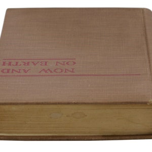 May include: A brown hardback book with the title "NOW AND ON EARTH" printed in red on the front cover.
