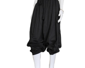 May include: Black harem pants with a drawstring waist and gathered ankles. The loose, flowing design creates a relaxed silhouette. These pants are made of a lightweight fabric, perfect for casual wear.