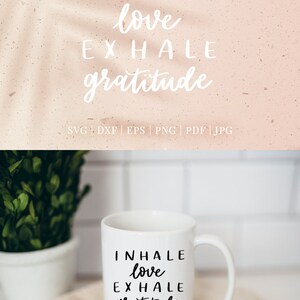 May include: White ceramic mug with black text that reads "INHALE love EXHALE gratitude". The mug is sitting on a wooden coaster with a beige fabric napkin.