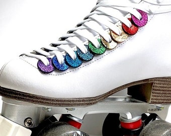 May include: White roller skates with rainbow glitter accents on the boot. The skates have black wheels and white trucks.