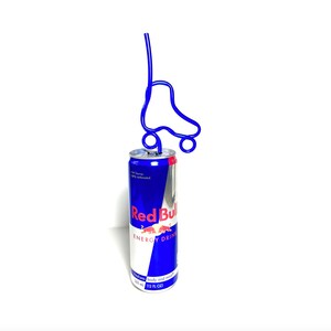 May include: A blue and silver Red Bull energy drink can with a blue roller skate-shaped straw. The can has the Red Bull logo and text. The straw is inserted into the top of the can. The can is 12 fl oz.