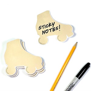 May include: A set of brown roller skate shaped sticky notes with the text "STICKY NOTES!" written on one of the notes. A yellow pencil and a black marker are also in the image.