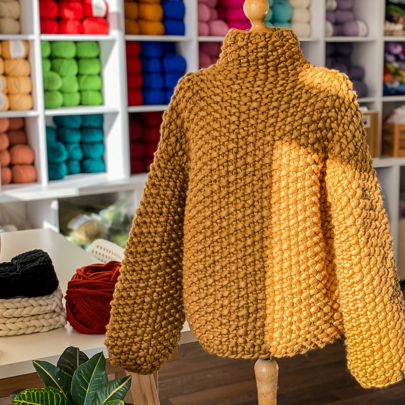 Mustard yellow oversized chunky knit sweater with voluminous sleeves.