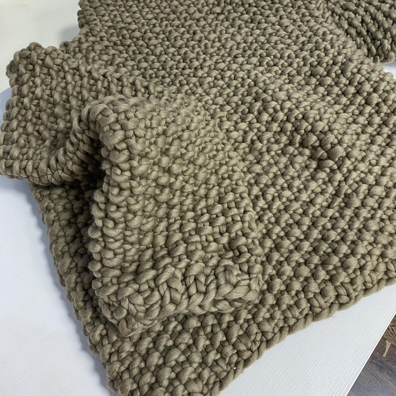 Grey oversized chunky knit sweater handmade from soft merino wool, shown flat.