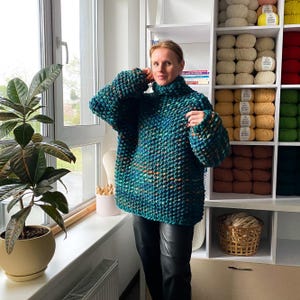 Oversized hand knit merino sweater styled indoors, showing relaxed fit and voluminous sleeves.