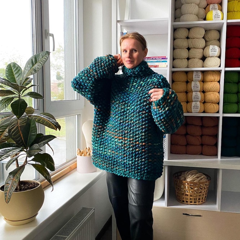 Oversized hand knit merino sweater styled indoors, showing relaxed fit and voluminous sleeves.