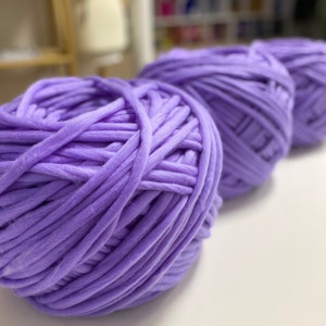 May include: Three balls of soft, lavender-colored yarn, perfect for knitting or crocheting.