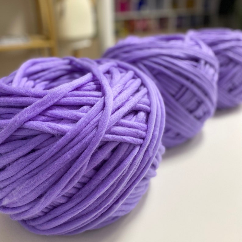 May include: Three balls of soft, lavender-colored yarn, perfect for knitting or crocheting.