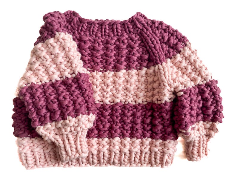 Front flat lay of a burgundy and pale pink striped cropped sweater with raglan sleeves, round ribbed neckline, cuffs and hem.