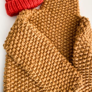 Mustard yellow chunky knit sweater styled with red ribbed beanie.