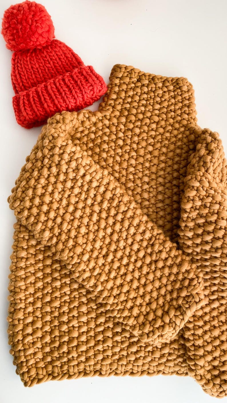 Mustard yellow chunky knit sweater styled with red ribbed beanie.