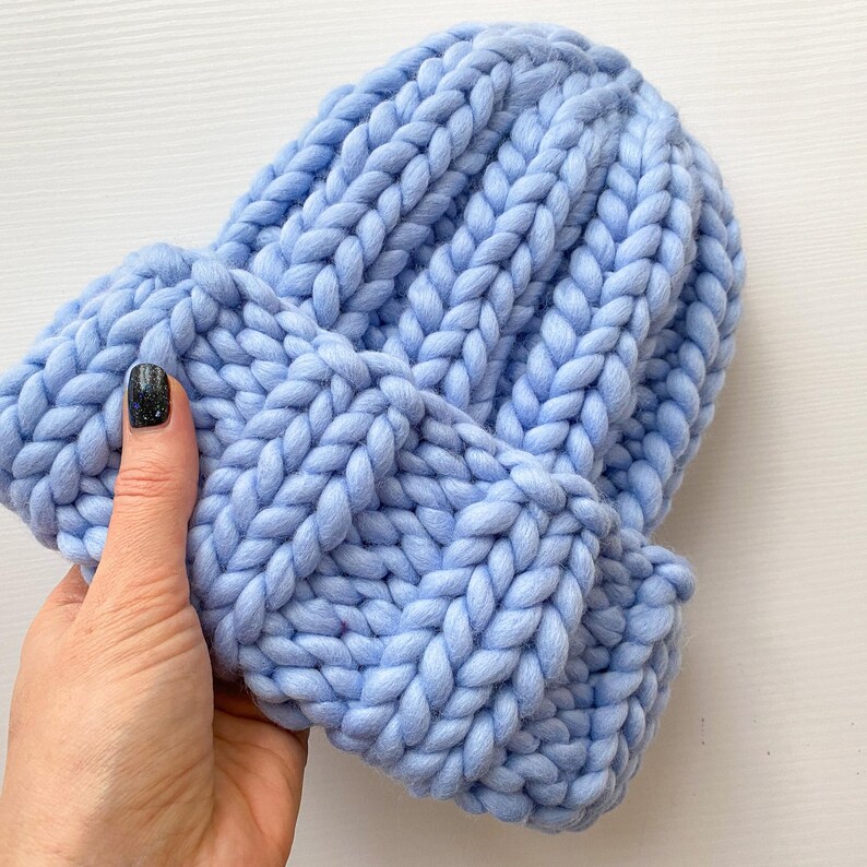 Chunky knit beanie with brim – light blue merino wool, hand-knit fisherman style, shown in hand.